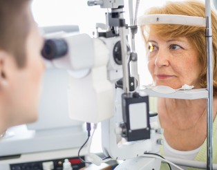 Senior woman visiting optician.