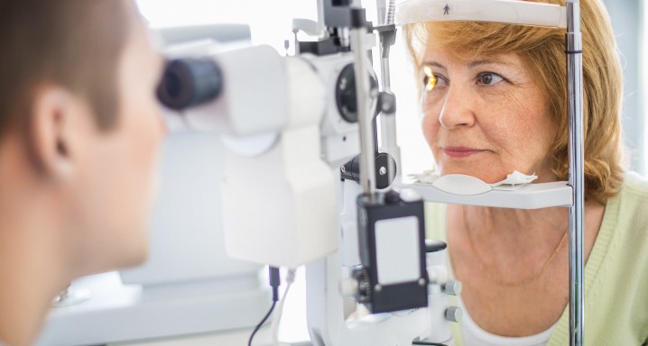 Senior woman visiting optician.